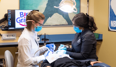 dentist and dental hygenest working on patient 2