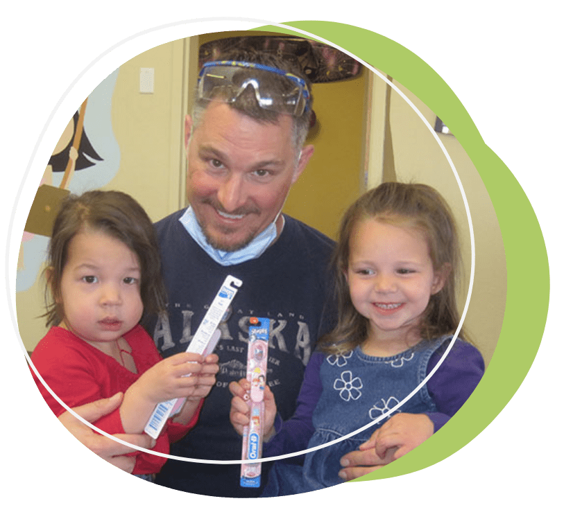 infant care, man holding two kids, holding tooth brushes