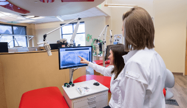 two dentists looking at x ray on screen